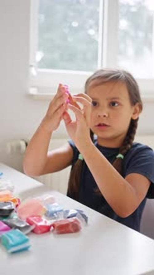 A Creative Child Engaging in an Exciting Play Session with Colorful Crafting Materials