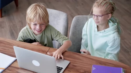 Online School Class Siblings Pupils Boy and Girl Learning Together Remotely Online at Home Looking