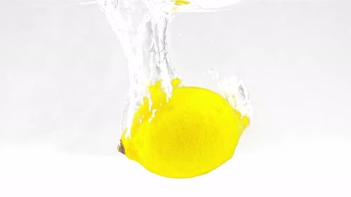 Yellow Lemon Dropped Into Clear Water