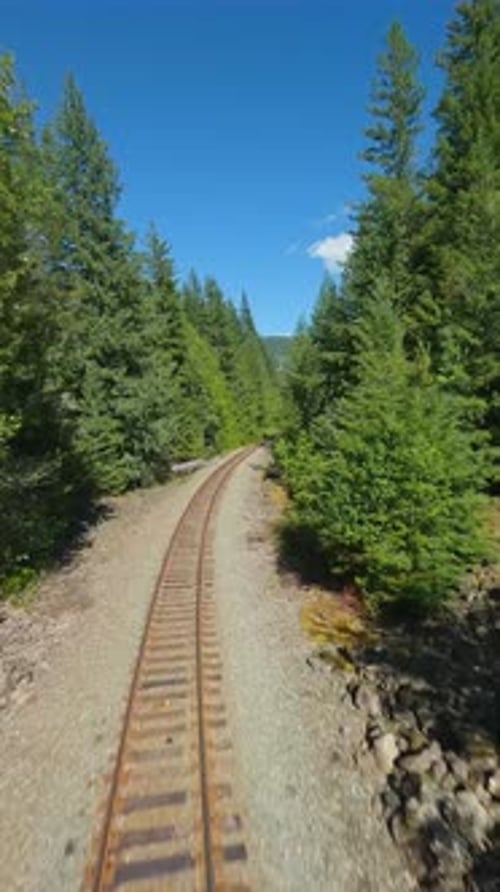 FPV Drone is Flying Fast Forward Over Railway Track Canada