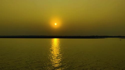 Golden Sun Reflecting On Calm River Water At Sunset. wide shot, sideways
