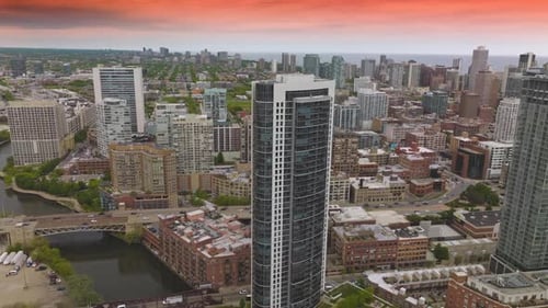 Scenery of beautiful Chicago with diverse buildings. Cars crossing bridges over the river.