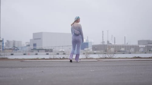Woman Stands in City Wearing Knitted Outfit