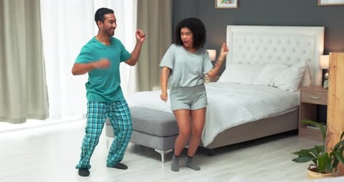 Happy Couple Dancing in Bedroom in Pajamas