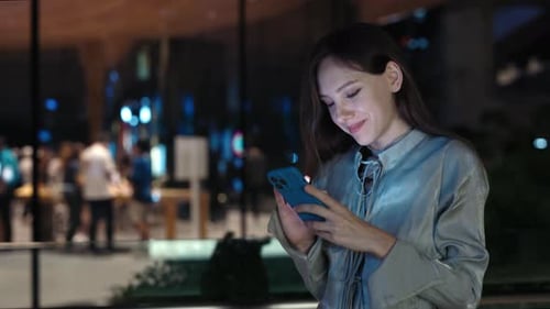 Adult Woman Scrolling Online Shop and Ordering Products While Standing Outside in the Evening