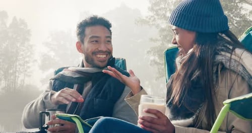 Young Couple Chatting Outdoors During Camping Trip