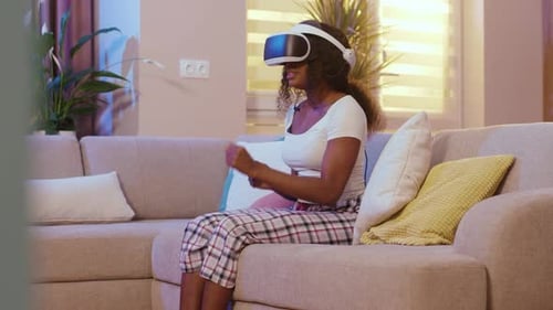 Woman experiences virtual reality while sitting on couch