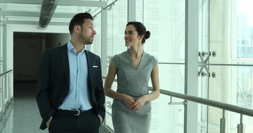 Business colleagues walking through office corridor