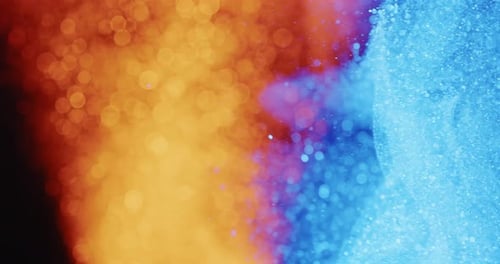 Swirling Orange And Blue Particles In Motion