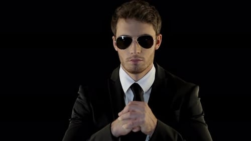 Stylish Man in Suit and Sunglasses on Black