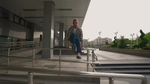 Man in Shirt Overcomes Obstacles on Way Using Acrobatic Stunts and Parkour