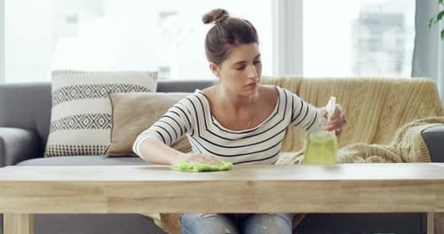 Woman Cleaning Wooden Table in Bright Home