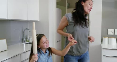 Happy Family Baking Cupcakes Together in Kitchen