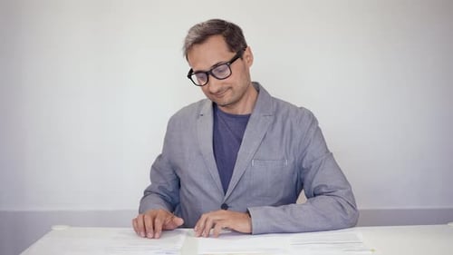 Happy Man Works with Documents