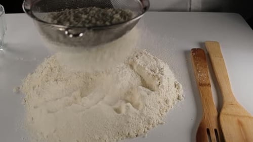 Sifting Flour for a Baking Recipe Close Up