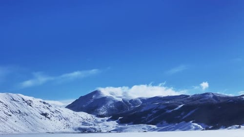 Drone Aerial Video Footage of Snowy Mountain Peak with Moving Clouds in Abruzzo Italy