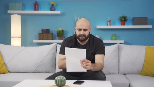 Happy Man Celebrates Good News Reading Document