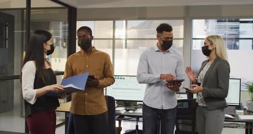 Colleagues Meet Wearing Face Masks in Modern Office
