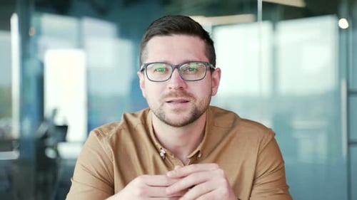 Webcam view. Close up. Confident businessman talking at a business meeting on a video call sitting
