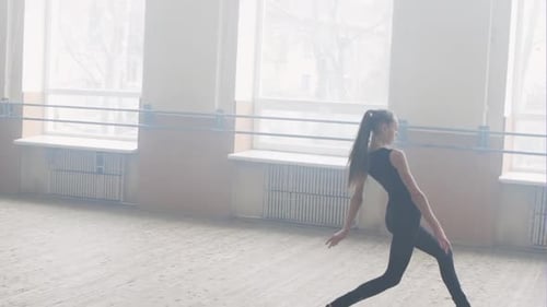 Teen Girl Dancer Practicing Ballet Moves in Studio