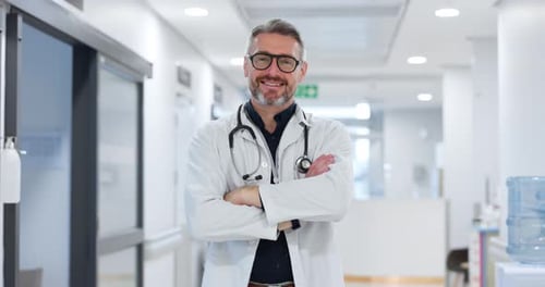 Professional, face and man or doctor with arms crossed for wellness, trust and service in hospital