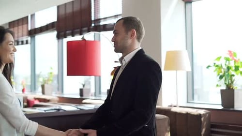 Business Colleagues Shaking Hands in Bright Modern Office