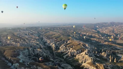 Epic cinematic drone shot over Cappadocia looking at the hot air balloons in Turkey