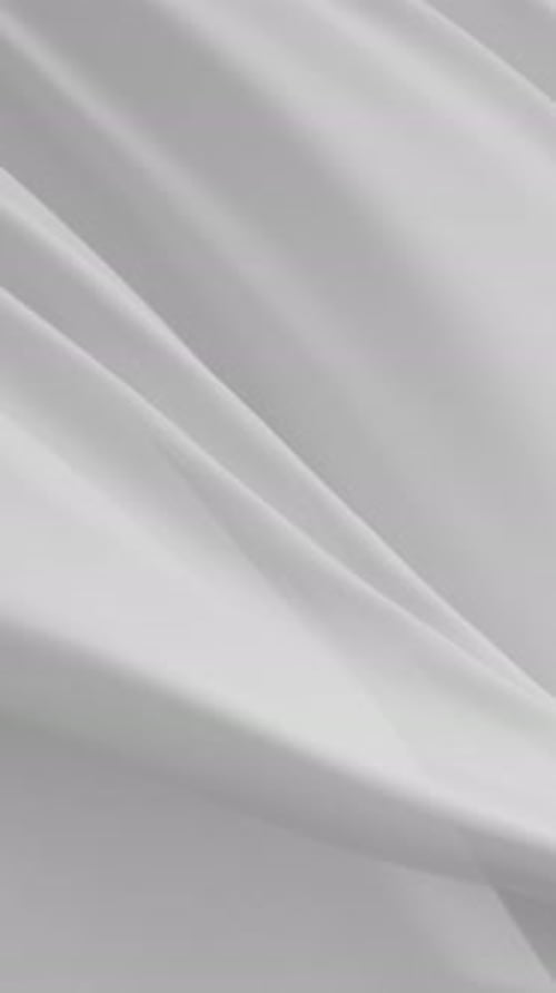 Soft White Clean Fabric Flowing Gracefully in Air Creating Elegant Minimal Texture Background with