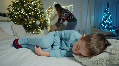 Sleeping Boy on Christmas Eve with Christmas Tree