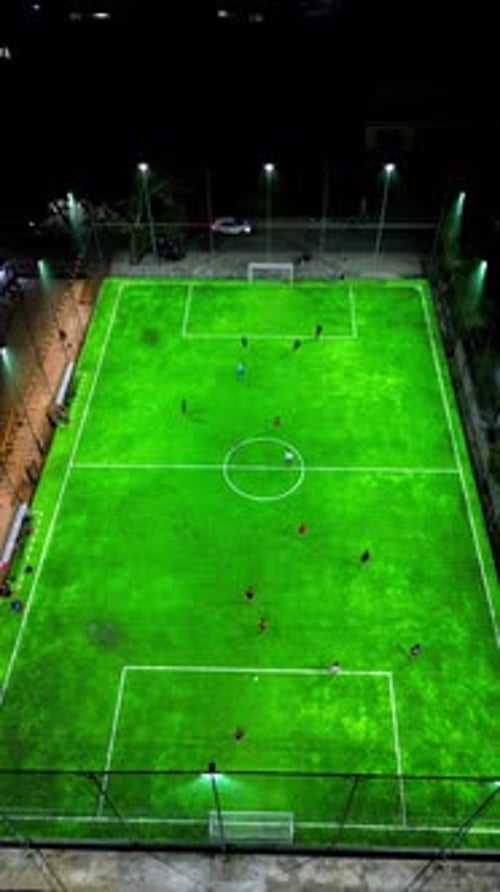 Vertical Drone Footage of mini football match, soccer. MiniFootball field and Footballers from drone