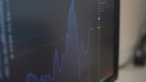 Closeup of Currency Graphs and Charts on Computer Screens in Modern Home Office Closeup of Computer