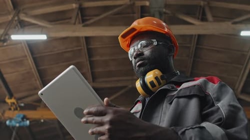 African American Factory Worker Using Digital Tablet