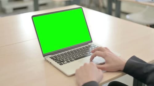 Close up of Businessman Working on Laptop with Green Screen