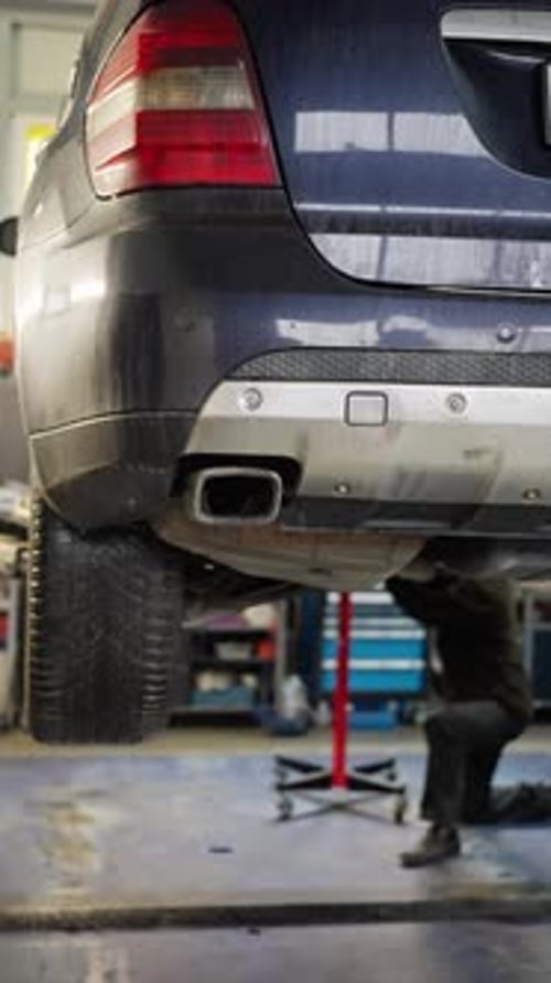 Car Repair Underway Automobile Technician Working on Suv Vehicle Vehicle Repair Scene with Mechanic