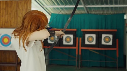 Redhead Woman Shooting an Arrow at a Target