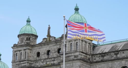 British Columbia Flag and Parliament Buildings in the background,Victoria, Canada.
