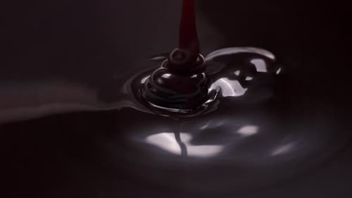 Pouring Dark Liquid in a Close Up Shot