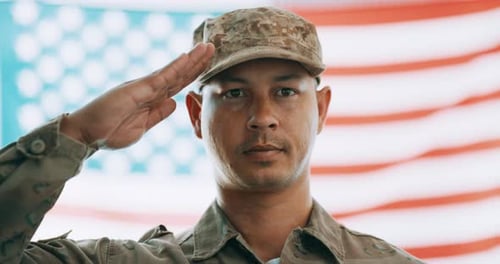Military Man Salutes in Front of American Flag