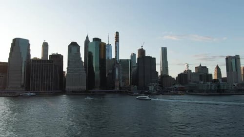 Wide angle aerial view of Lower Manhattan, New York City with boats on the East River at dusk on a c