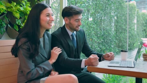 Business Colleagues Talking and Using Laptop Indoors