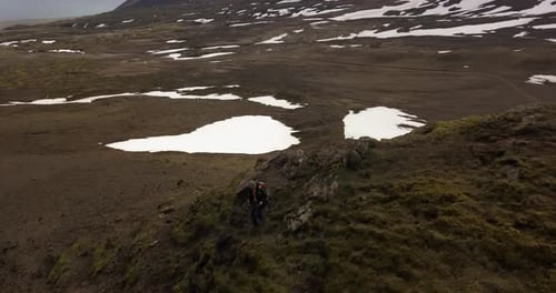 Lonely hiker walking in the open landscape of Iceland, aerial