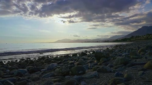 Sunset at Playa de los Monteros on a cloudy day, Marbella, Spain