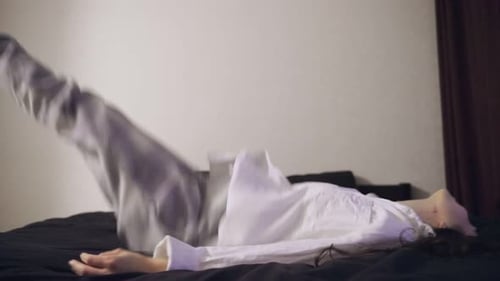 Cheerful Tired Young Woman Falling Down in Bed at Home