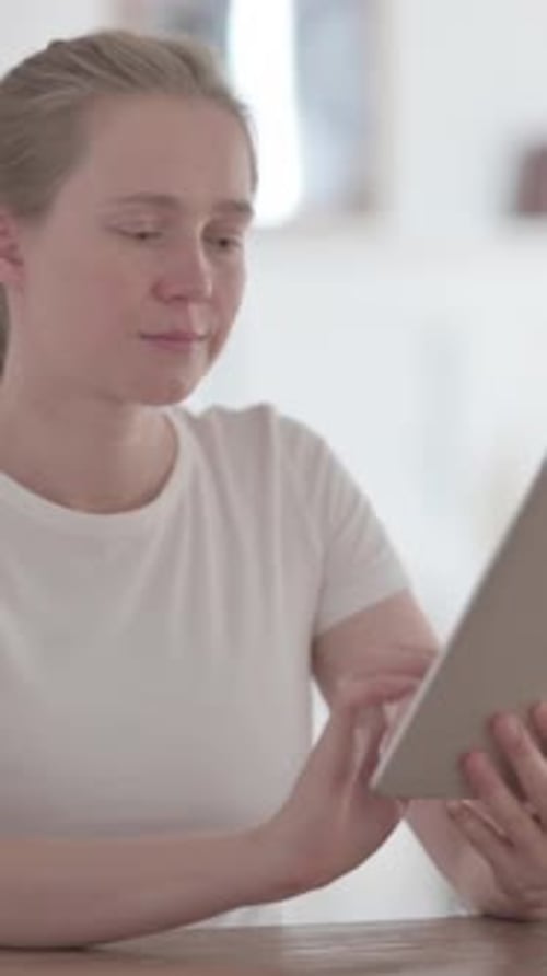 Beautiful Young Woman using Tablet while Sitting in Office, Vertical Video