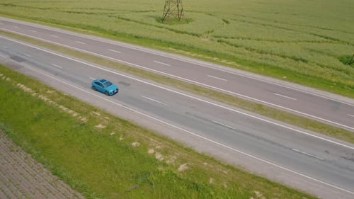 Beautiful blue car driving on a highway. Luxury electric automobile moving on a road