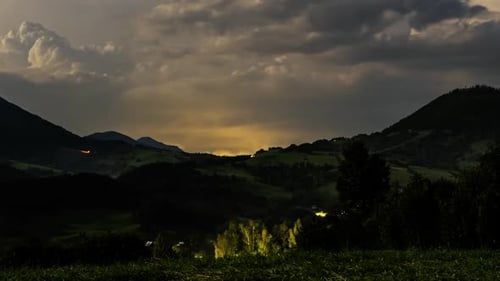 Dramatic Lightning Storm Over Rural Mountain Landscape at Night