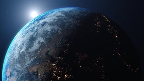 Dawn of a new day, as the sun rises behind planet Earth in a sunrise top view from space.