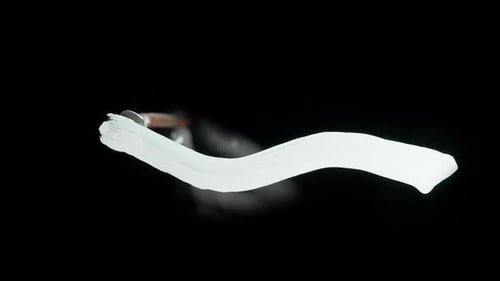 Person Using Brush with Acrylic Oil Medium White Paint and Drawing Wave Stroke Directly on Black
