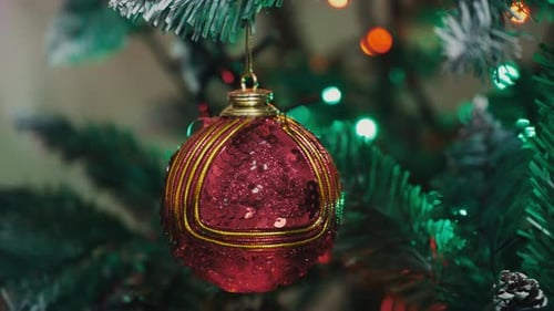 Glittering Christmas Ornament Hanging on Tree
