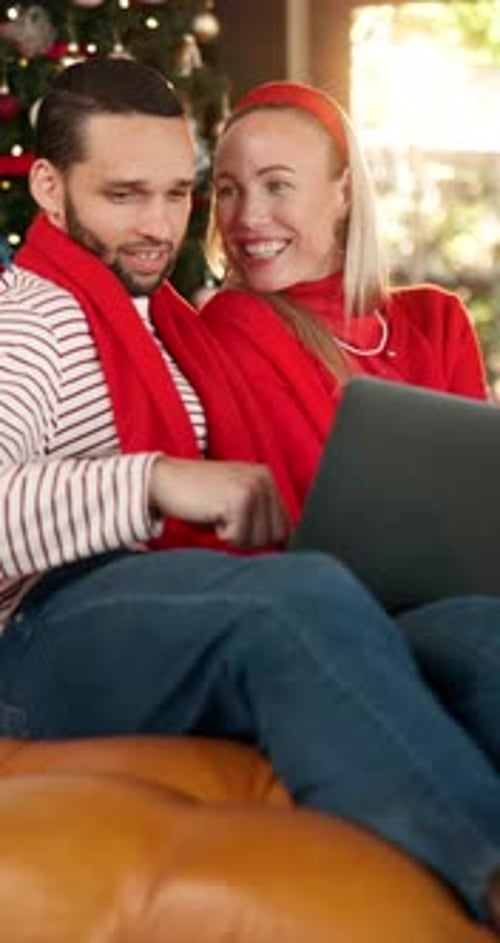 Smiling Couple Using Laptop in Cozy Christmas Home